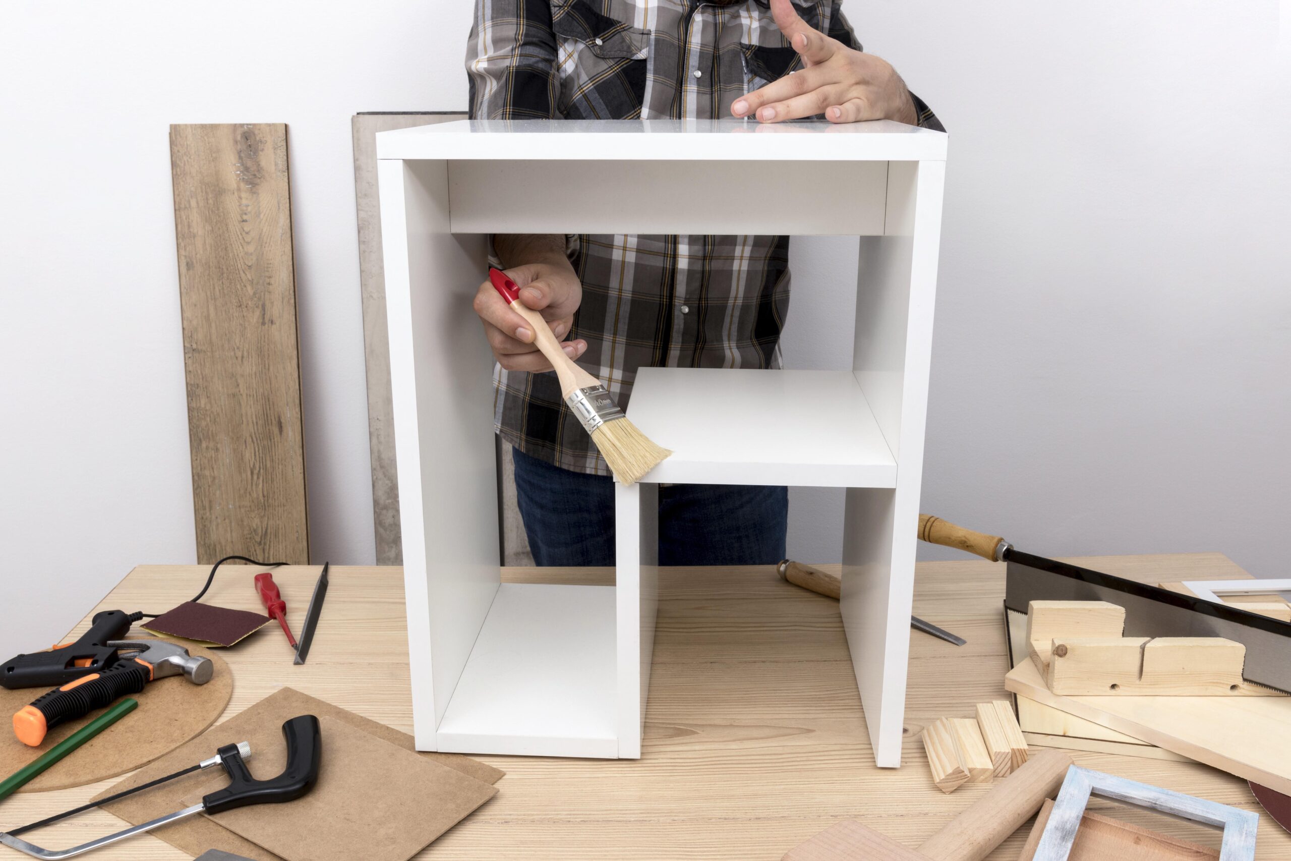man creating cabinet from wood front view scaled