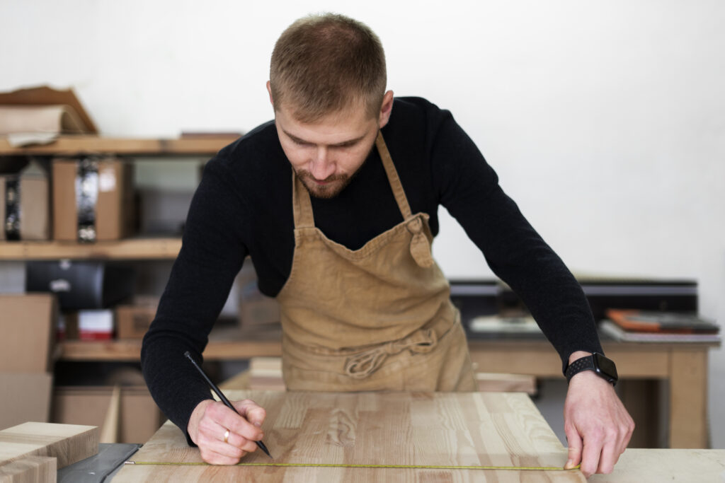 man working wood engraving workshop